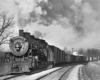 Steam locomotive smoking with freight train in curve