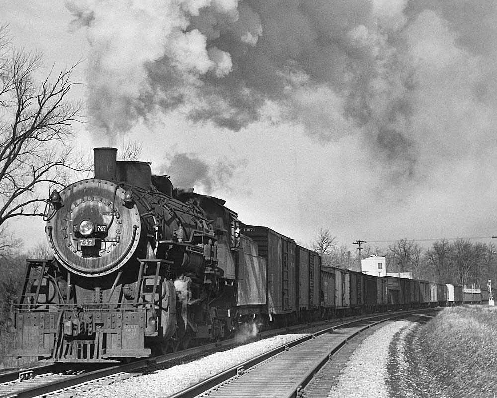 Steam locomotive smoking with freight train in curve
