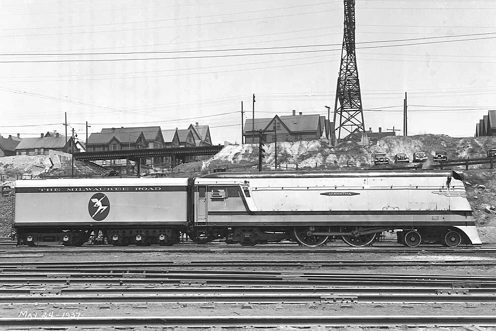 Broadside of streamlined steam locomotive in valley