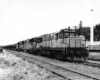 Three diesel locomotives on train of logs