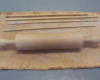 A rolling pin and dowels resting on a piece of canvas