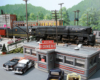 A train passes behind a busy vintage restaurant