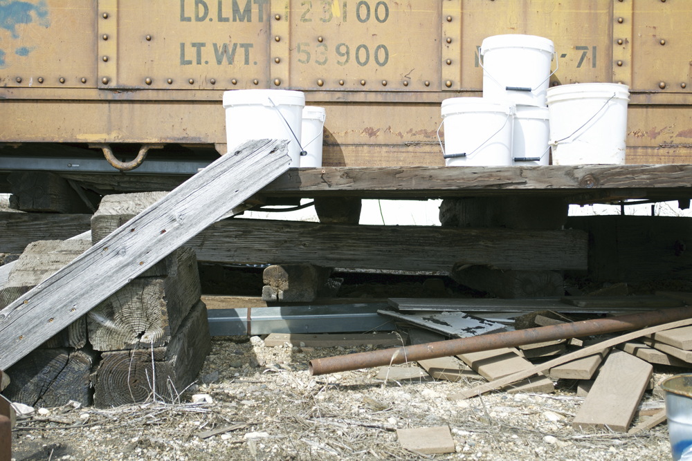 View of railroad tie cribbing supporting old railroad car