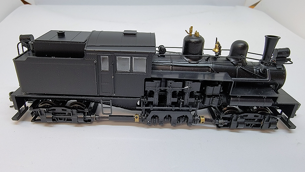 Black steam locomotive model on a table.