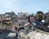 A train traveling alongside a waterfront town