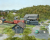 A train passes by rail served industrial sites