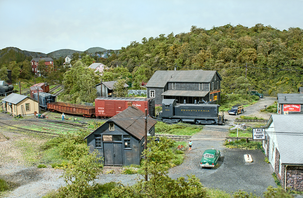 A train passes through industrial sites served by rail