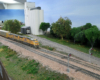 Yellow Union Pacific locomotives lead a freight train around a curve.