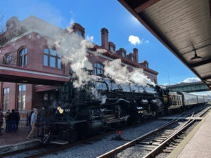 steam locomotive outside depot