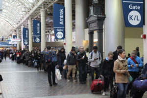 People standing in line in hallway of railroad station