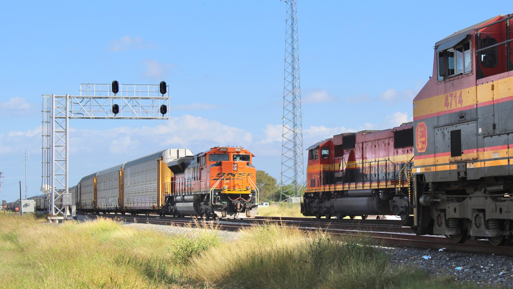 Train of auto racks meets locomotives