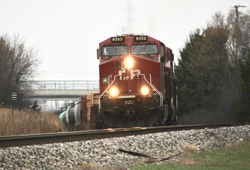 Train with red locomotives rounds curve