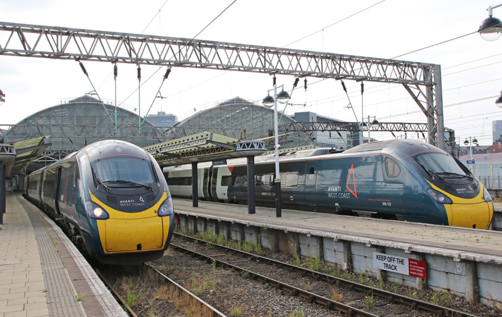 Blue high speed trainsets with yellow noses at station