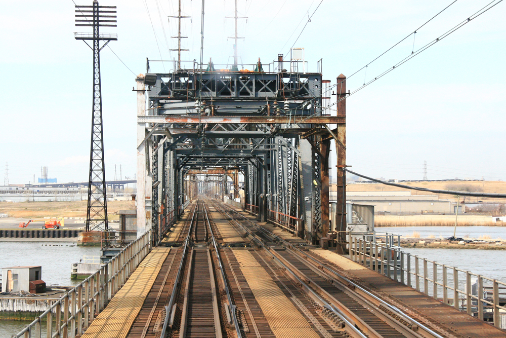 Two-track rail bridge as seen from on train