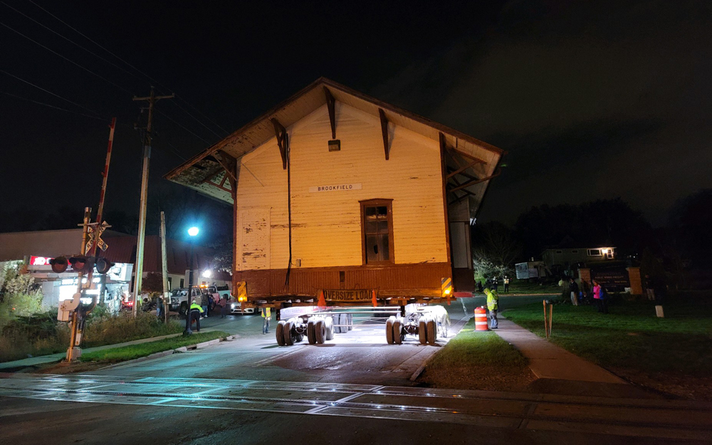 Station building being moved on street