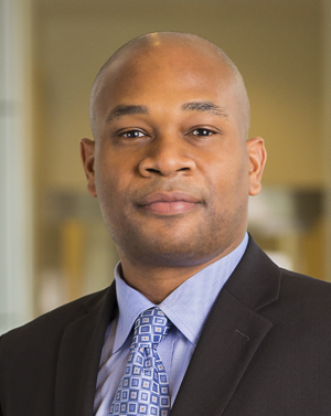 Man in dark coat with blue shirt and tie