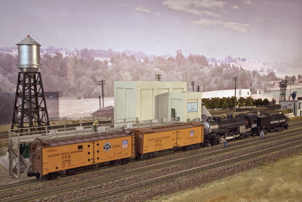 A steam locomotive with refrigerator cars.