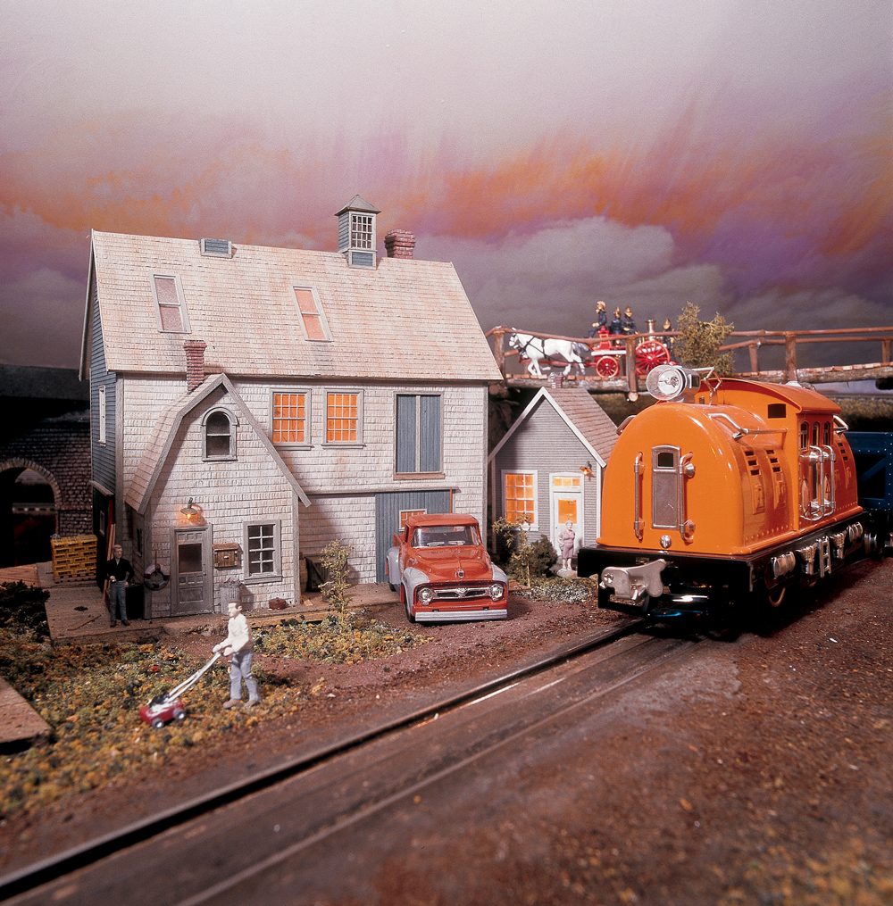Prewar electric engine and house on model train layout