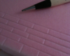 Mechanical pencil on top of pink insulation foam