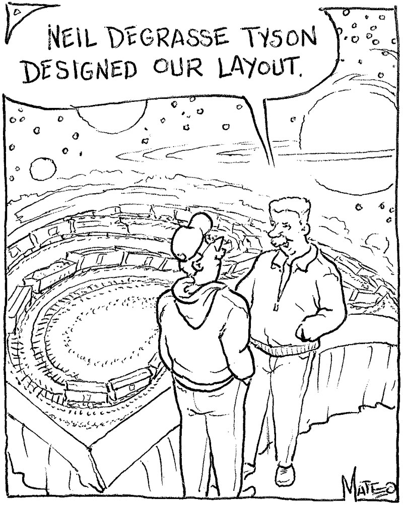 Two men stand next to a layout dominated by a huge backdrop depicting a star- and planet-filled night sky.