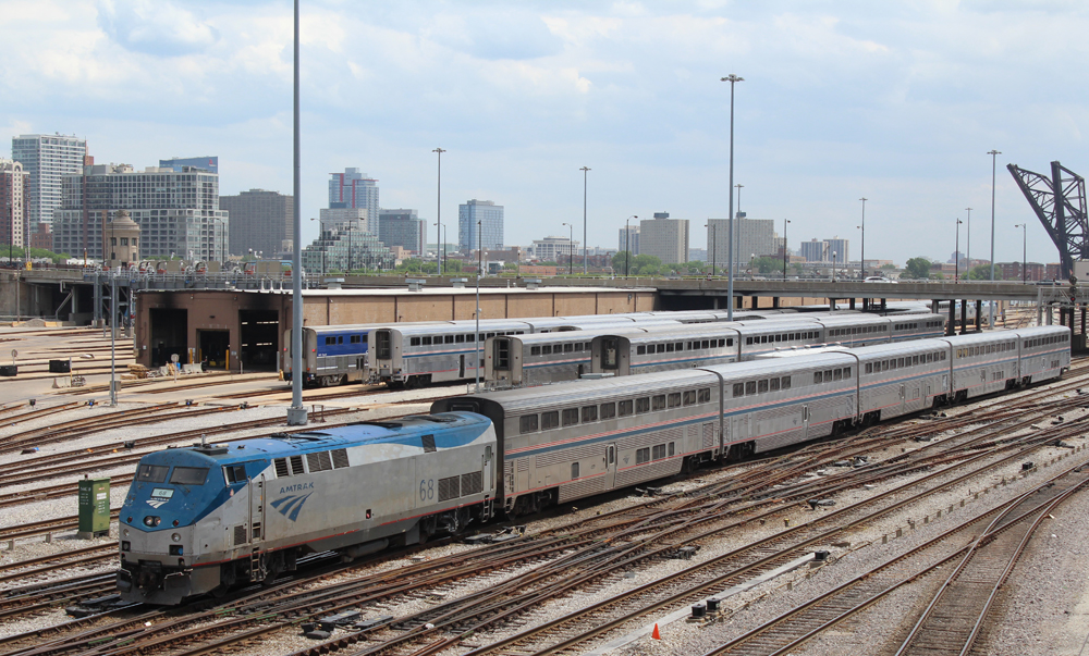 Passenger train passes yard of passengrer equipment