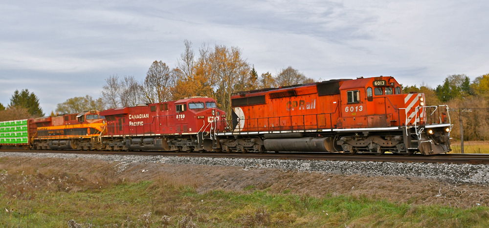 Two Canadian Pacific locomotives and one from Kansas City Southern on a train