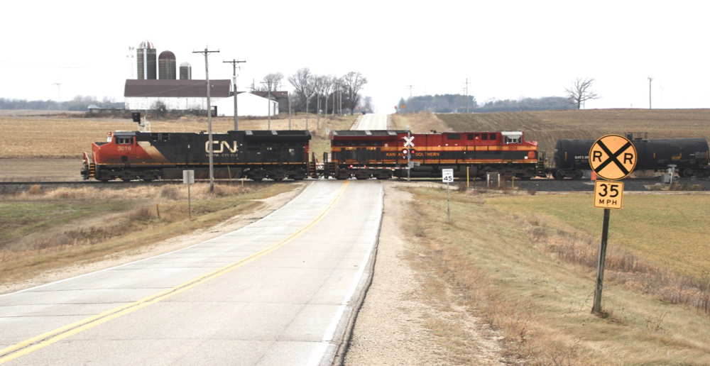 Train with two locomotives at rural grade crossing