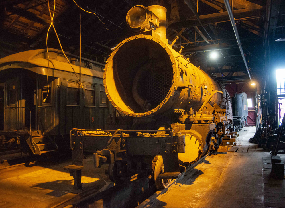 Partially disassembled steam locomotive in roundhourse