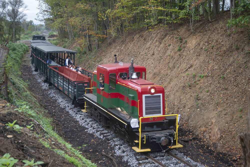 Train with green and red center-cab diesel