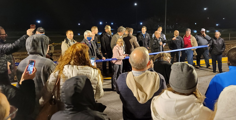 People watching ribbon-cutting ceremony