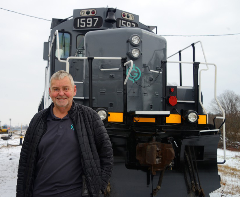 Man standing in front of gray locomotive