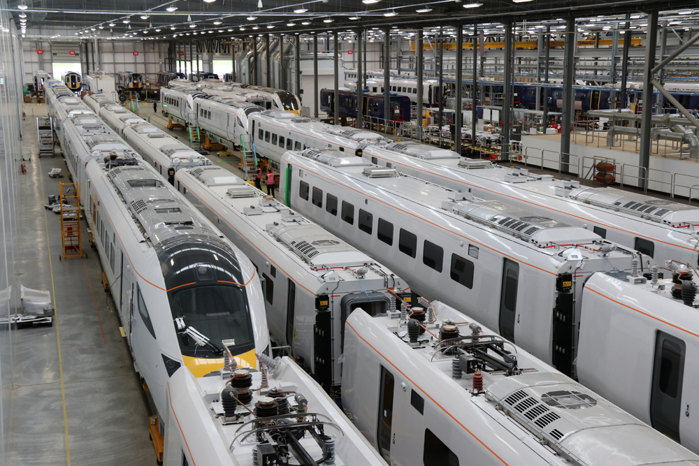 Factory floor full of passenger trains under construction