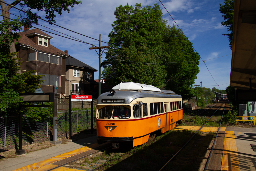 Yellow and white streetcar at station