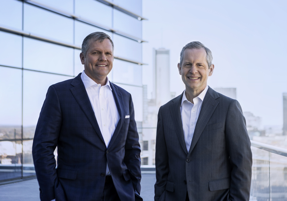 Two men with city in background