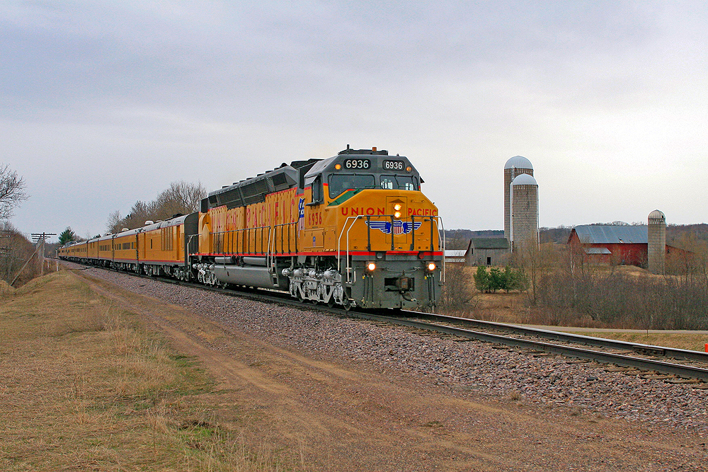 Top preserved diesel locomotives: A large yellow Union Pacific diesel locomotive leads a train over the plains.