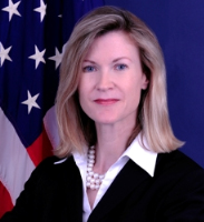 Woman in front of U.S. flag