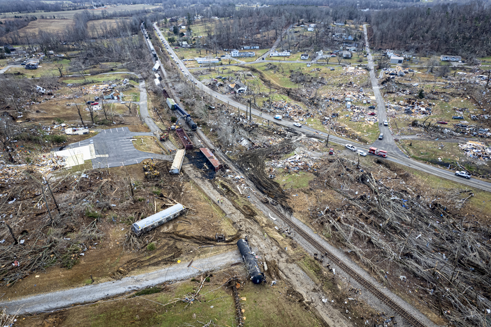 Aereal view showing debris from buildings and flattened trees as well as derailed railcars