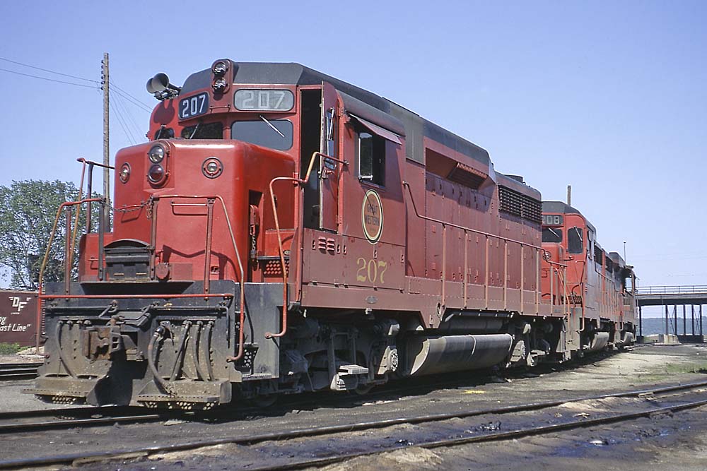 Red and black diesel locomotives parked on curve
