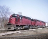 Three red diesels lead freight train