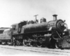 Steam locomotive coupled to passenger train
