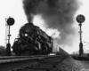 Steam locomotive with auxiliary tender powers freight train between signals