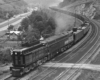Large locomotive with coal train on curve