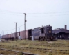 Blue diesel locomotive with train of maroon boxcars