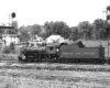 Steam locomotive framed between signal masts