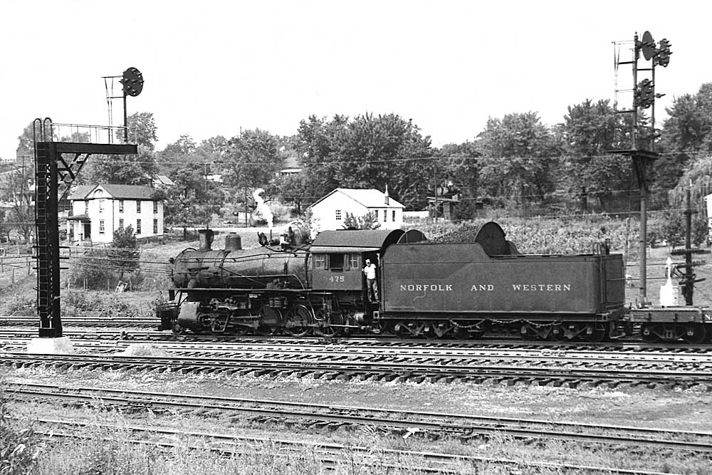 Steam locomotive framed between signal masts