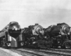 Three steam locomotives line up in yard