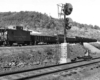 Train passes behind signal on elevated trackage