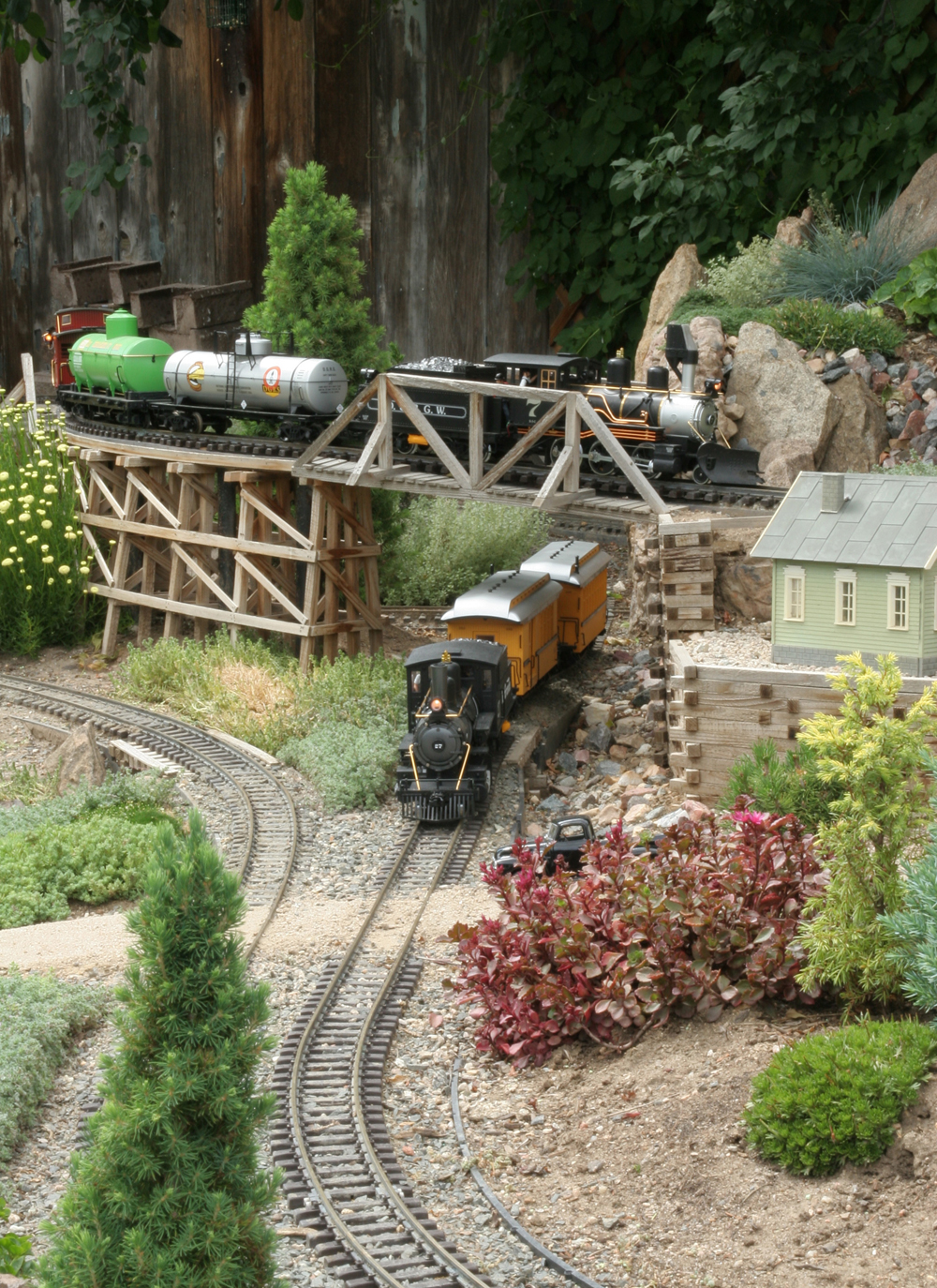 Model steam engine in a garden railway