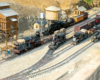 Four model steam locomotives on a garden railroad