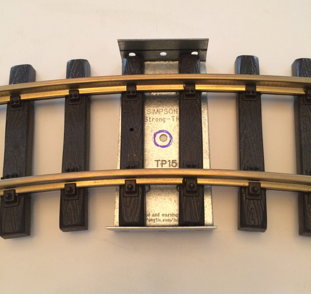 Clamp under a piece of track